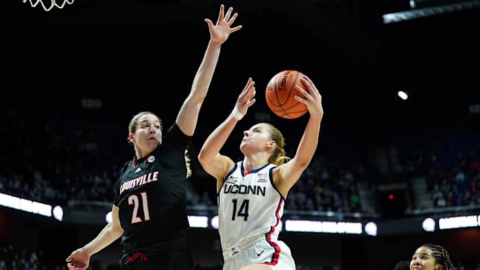 UConn forward Dorka Juhasz (14) shoots the ball against Louisville Cardinals forward Emily Engstler (21).